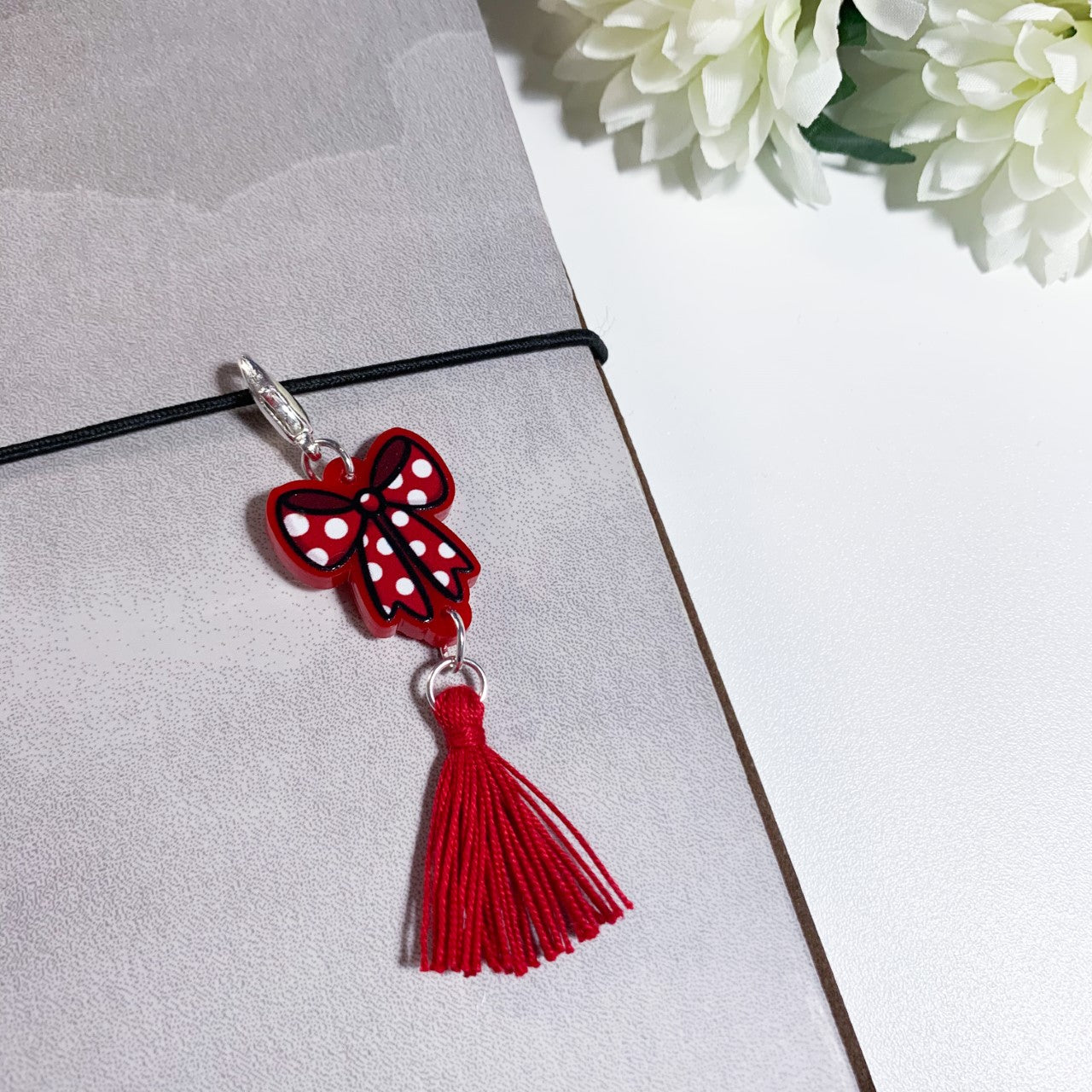 Red bow charm with tassel