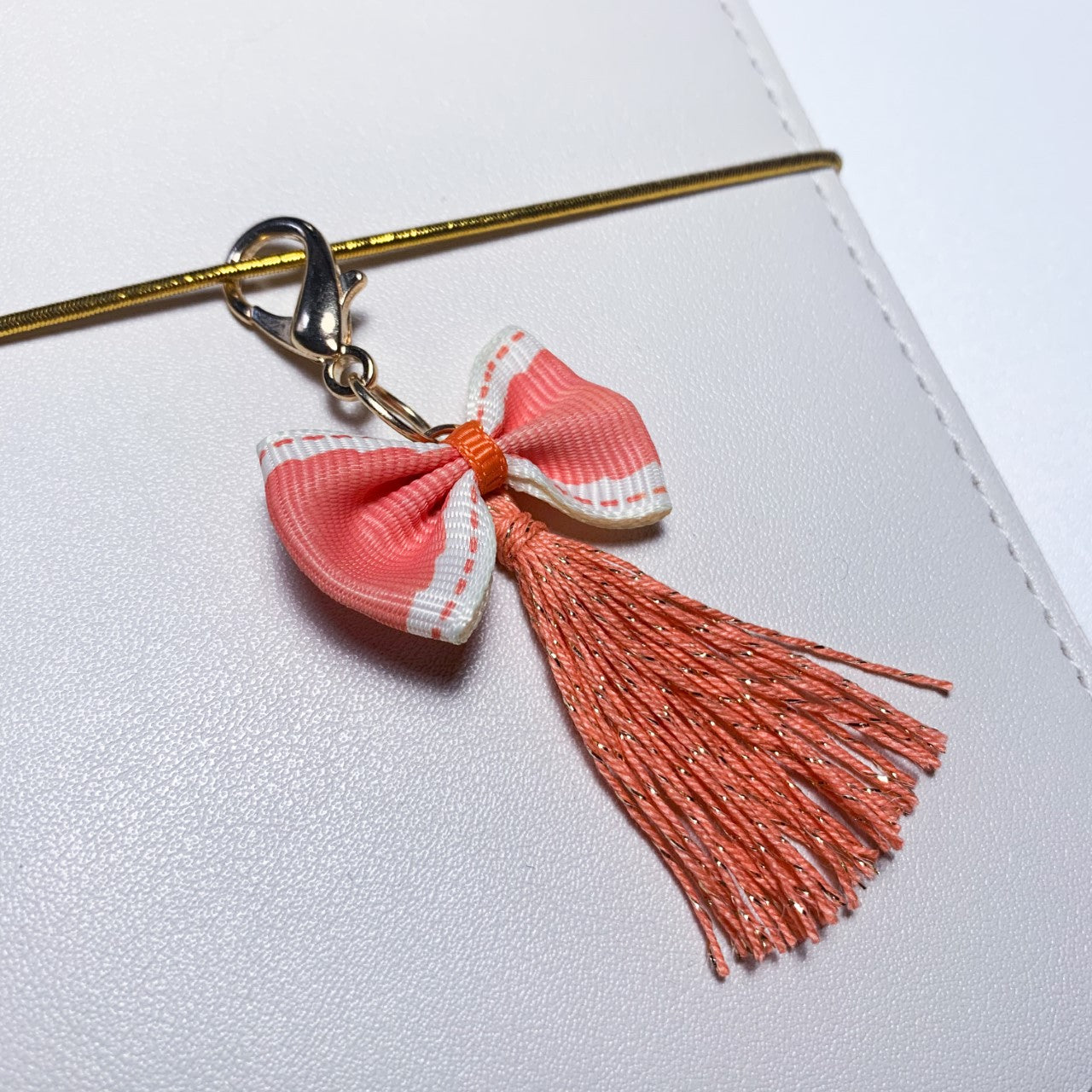 Bow and tassel charm