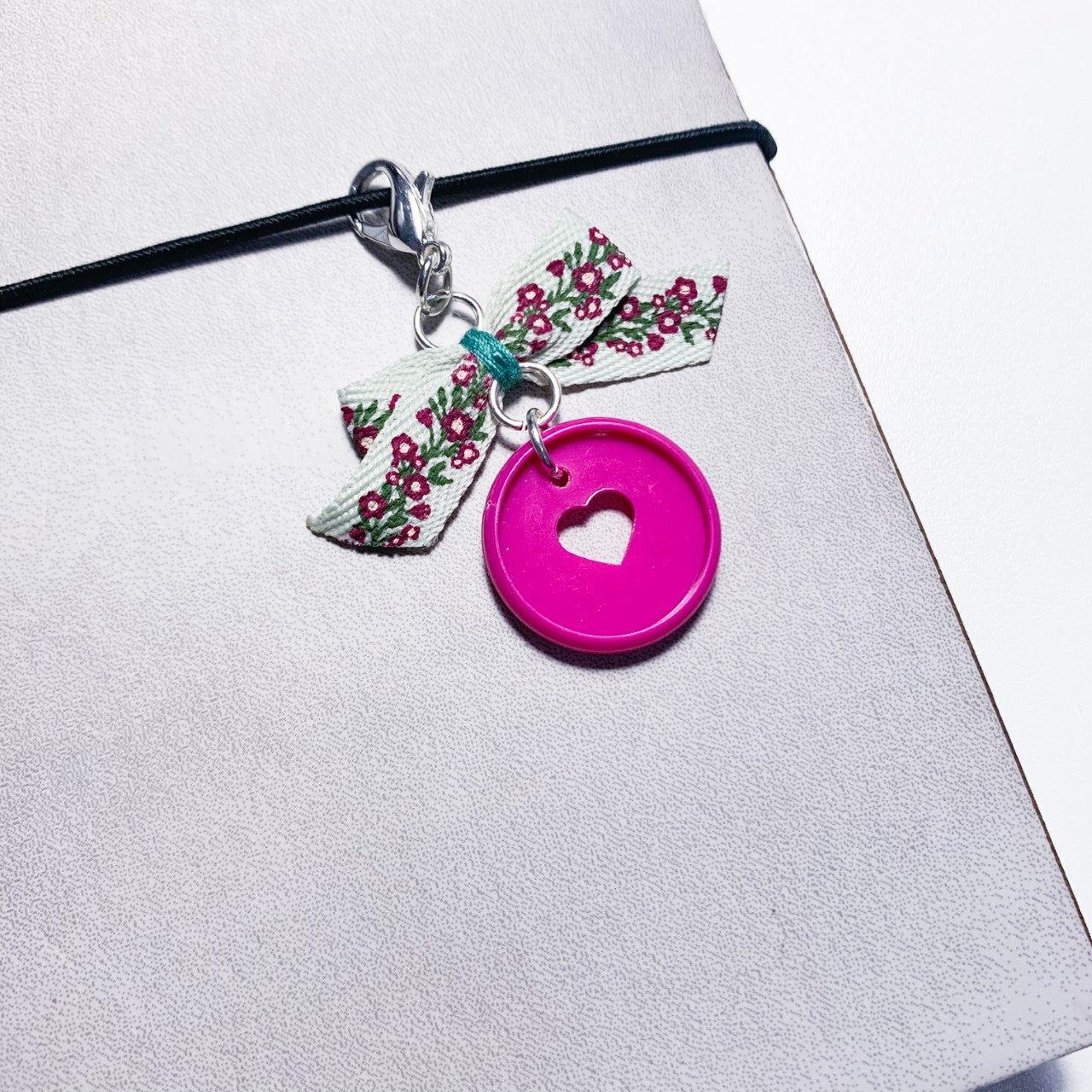 Pink disc charm with floral bow